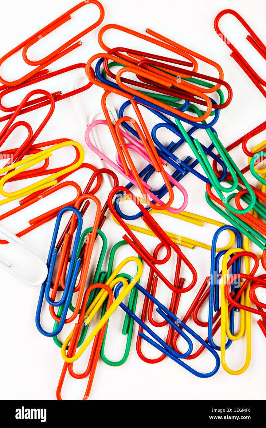 Colorful paper clips on white background. Vertical image. Stock Photo