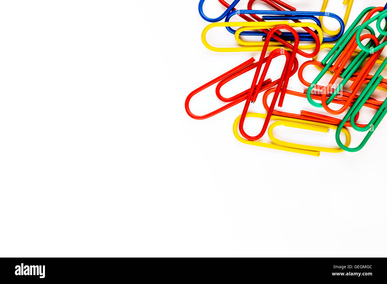 Colorful paper clips on white background. Horizontal image. Stock Photo
