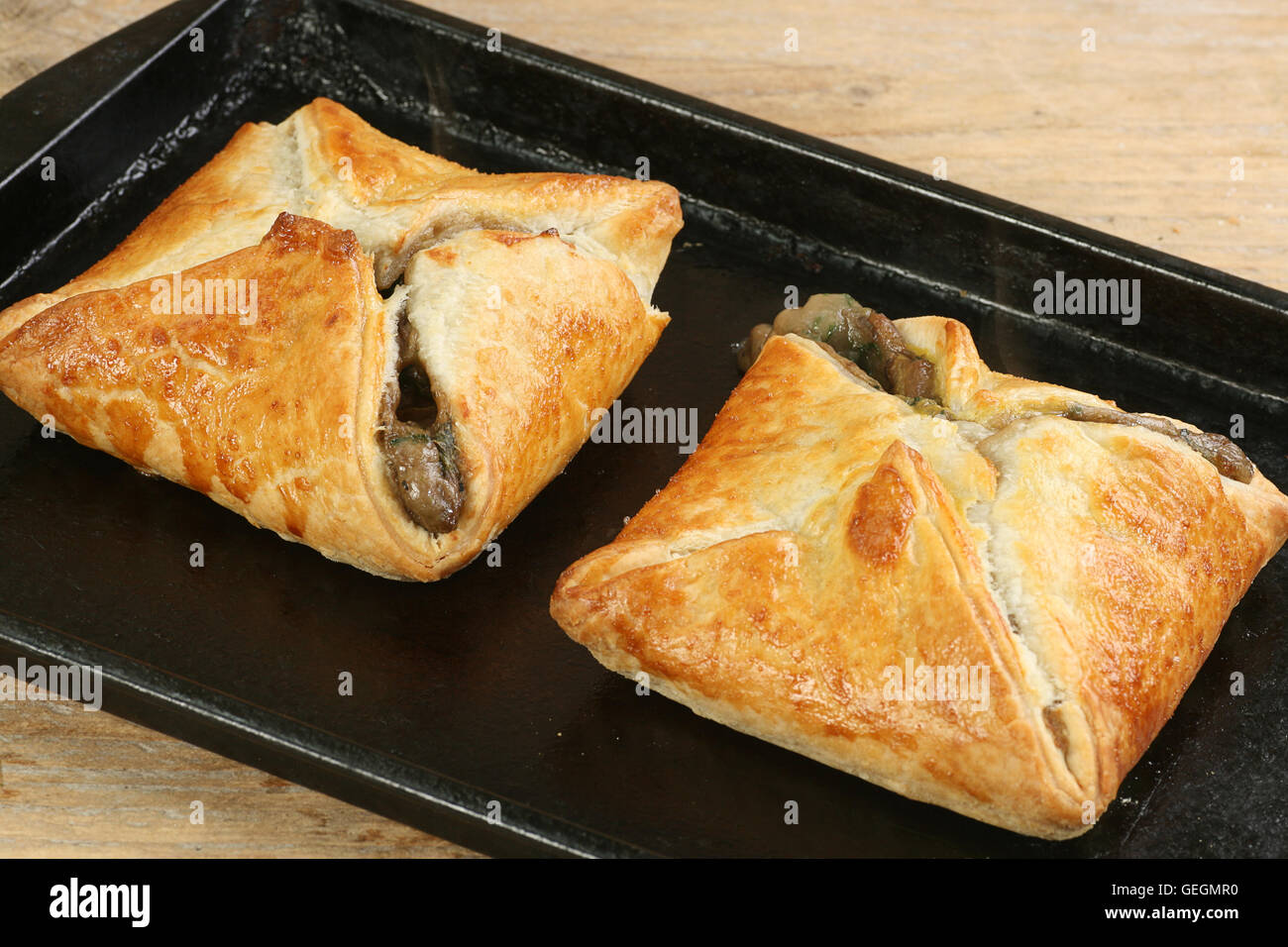 stilton and mushroom en croute on a baking tray Stock Photo Alamy