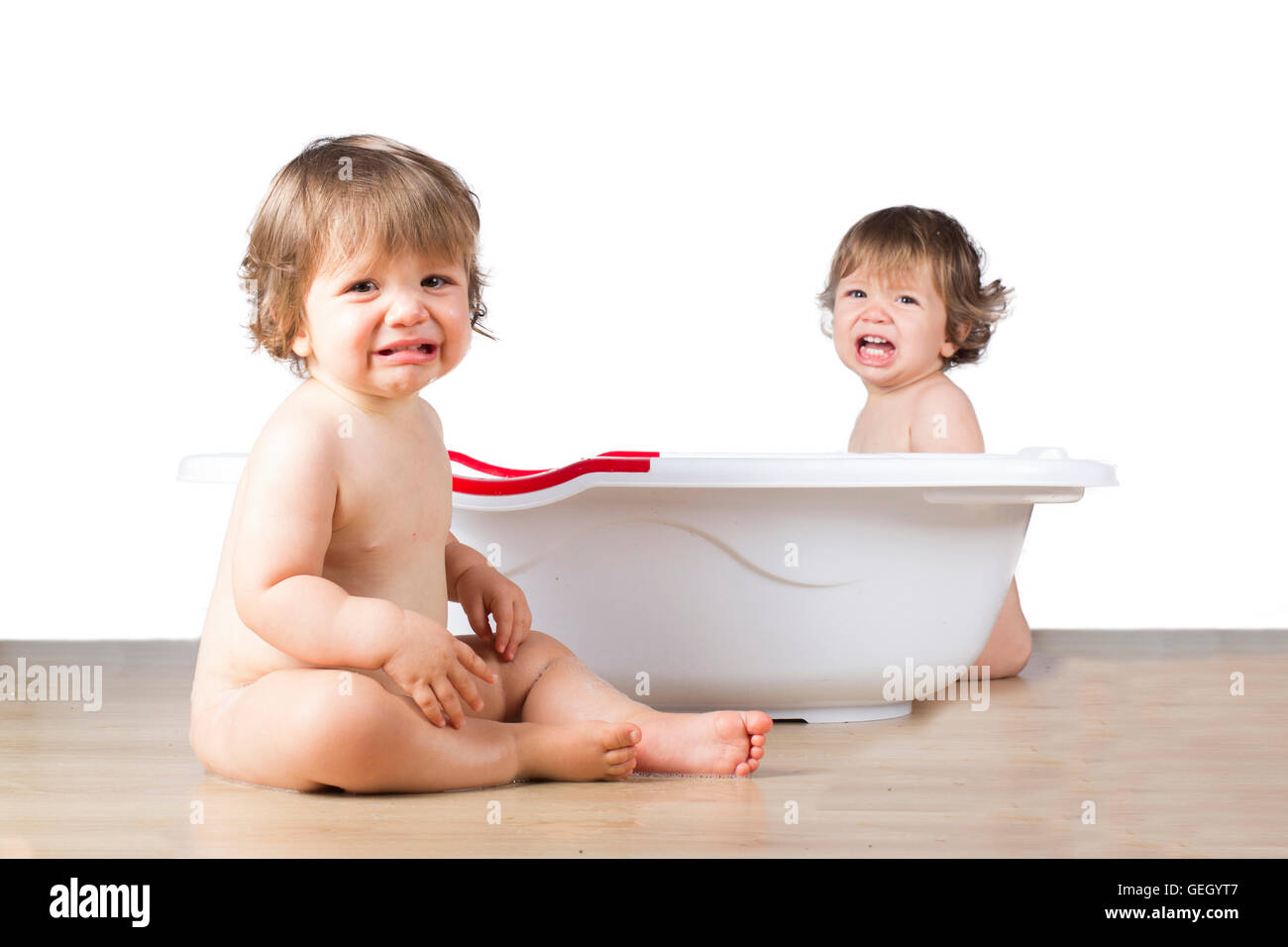 baby crying next to bath tub Stock Photo Alamy