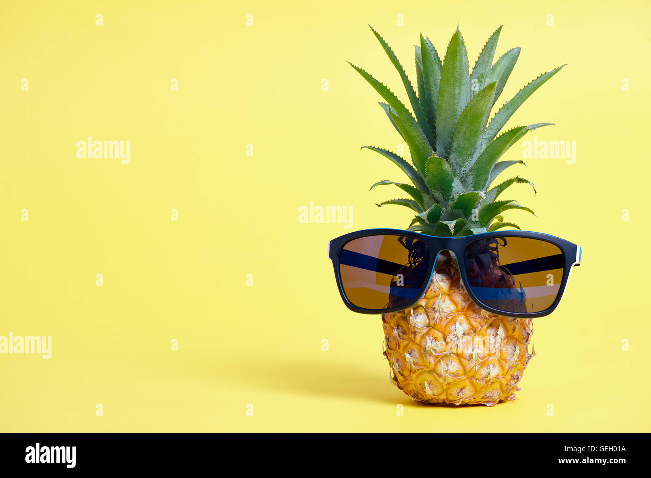 Pineapple with sunglasses on yellow background Stock Photo Alamy