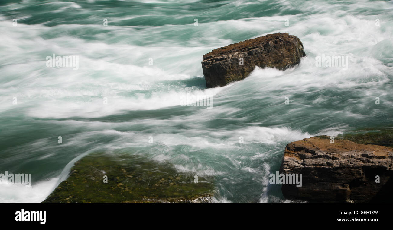 Rushing Water with Rock Stock Photo - Alamy