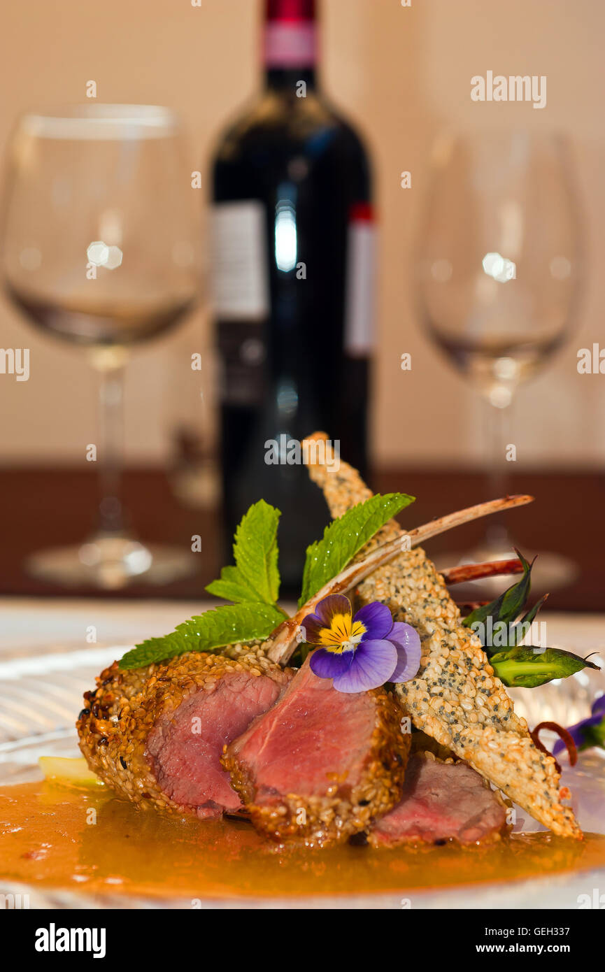 Lamb chops with red wine bottle Stock Photo Alamy