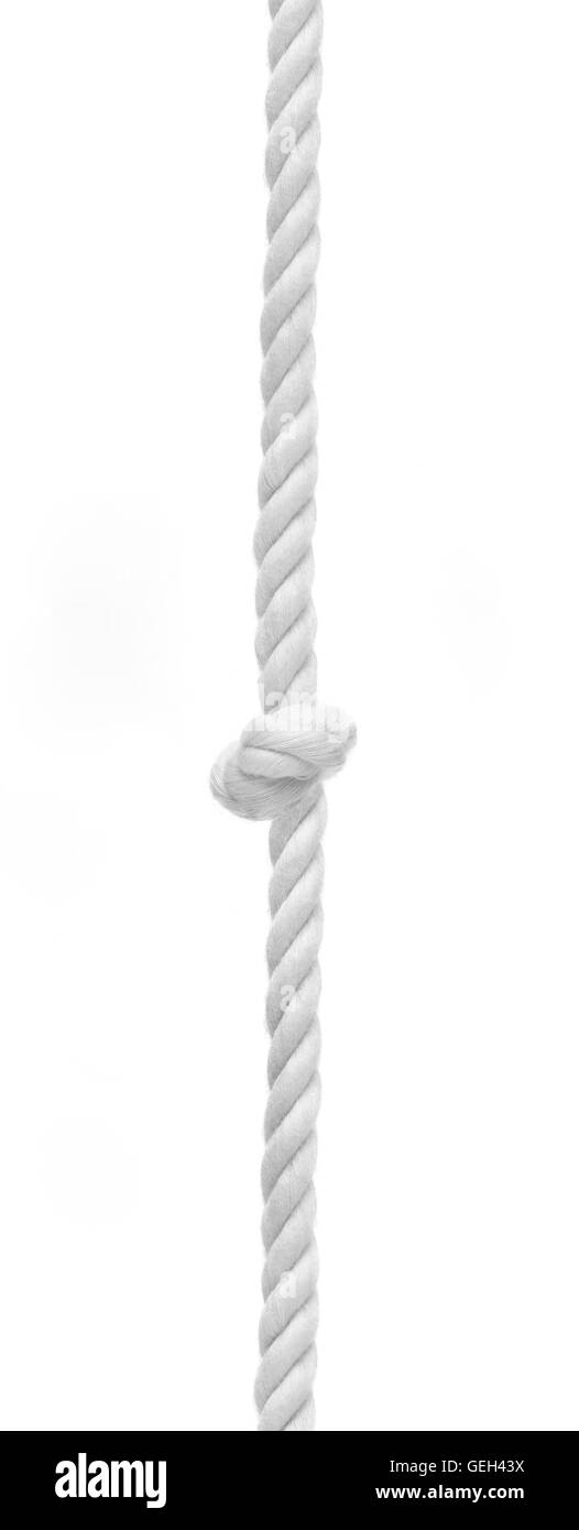 Braided rope with central knot against white background. Trouble concept Stock Photo