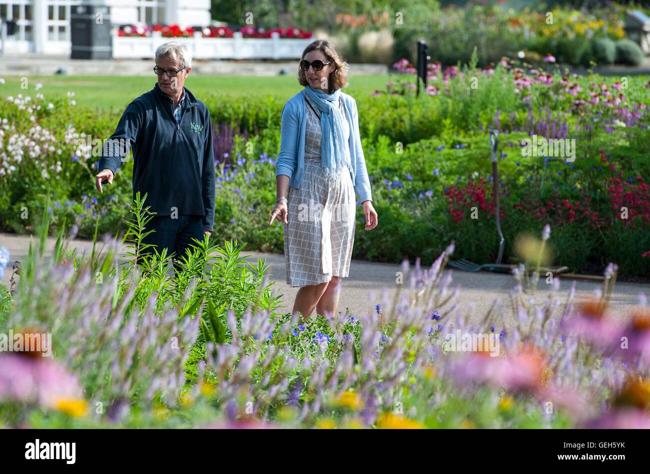 Staff walk through part of the Great Broad Walk Borders at Kew Gardens