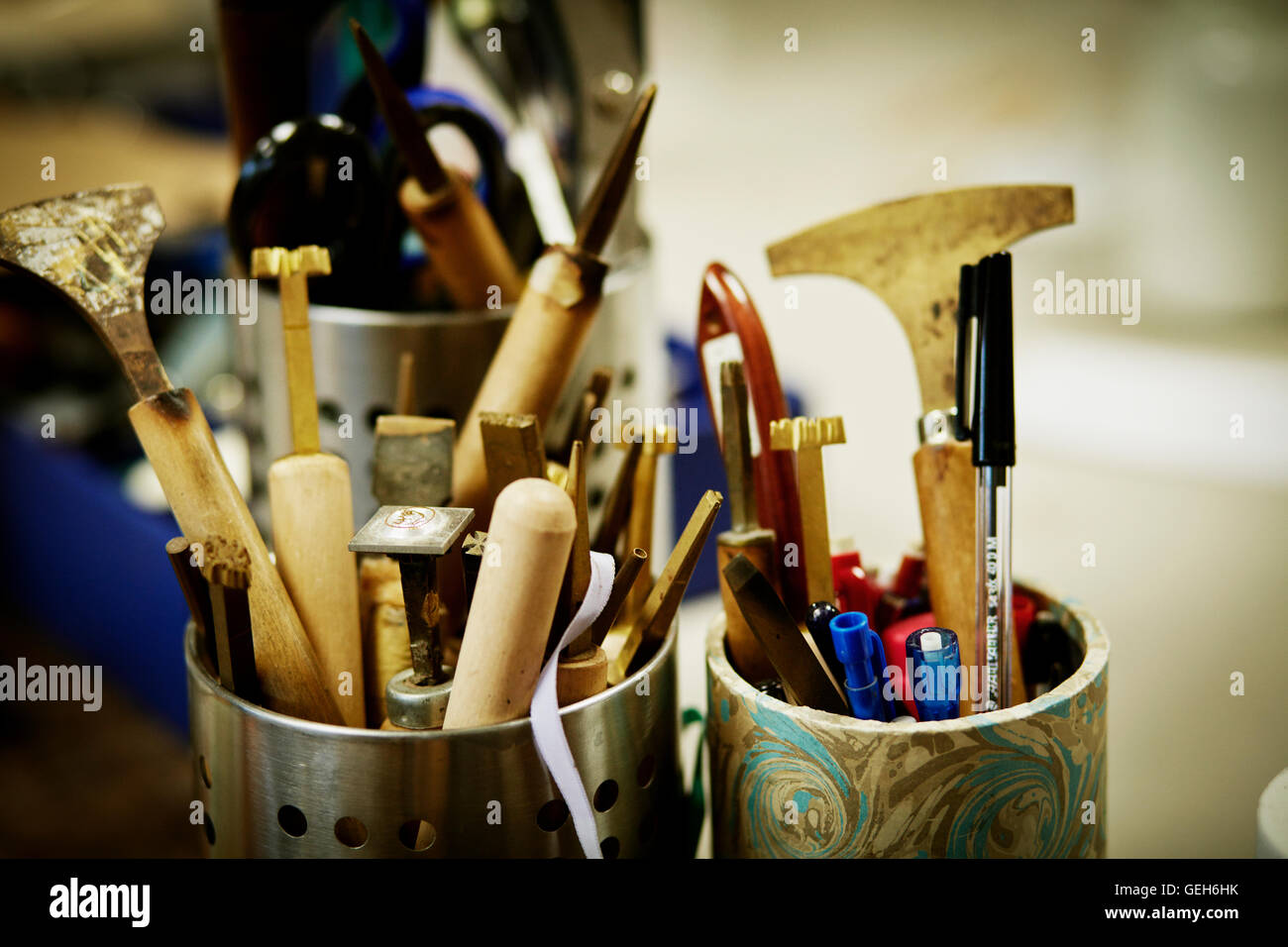 Metal pots full of hand tools for skilled work, for book binding tasks. Stock Photo