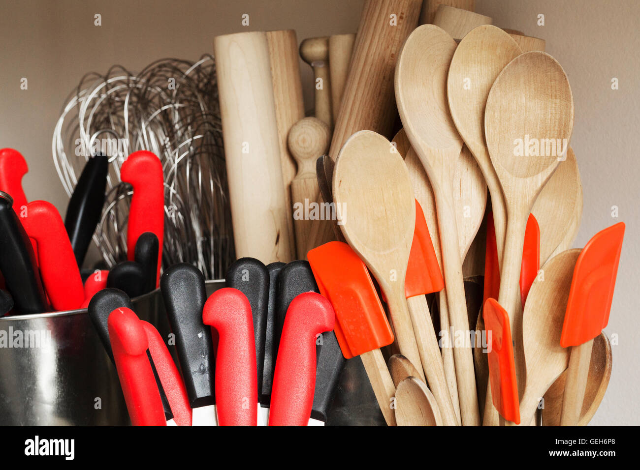 Selection of cooking utensils, wooden spoons, spatulas, rolling pins, whisks and kitchen knives. Stock Photo