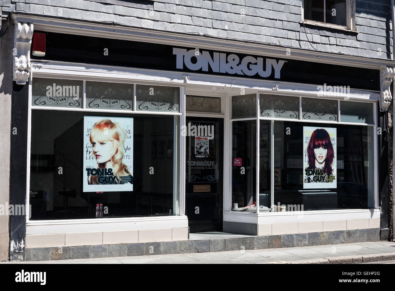 TRURO, CORNWALL, UK - JULY 17, 2016: Toni and Guy Hair Salon Window Store. Front of Toni&Guy beauty shop with advertising . Stock Photo