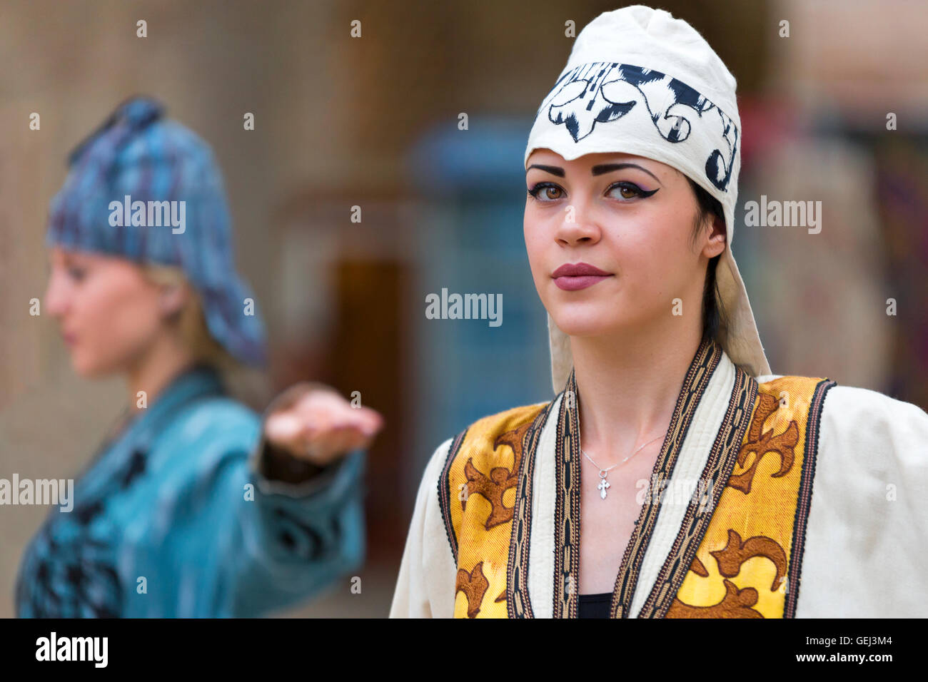 Uzbek model presenting local hats and clothes in Bukhara, Uzbekistan. Stock Photo