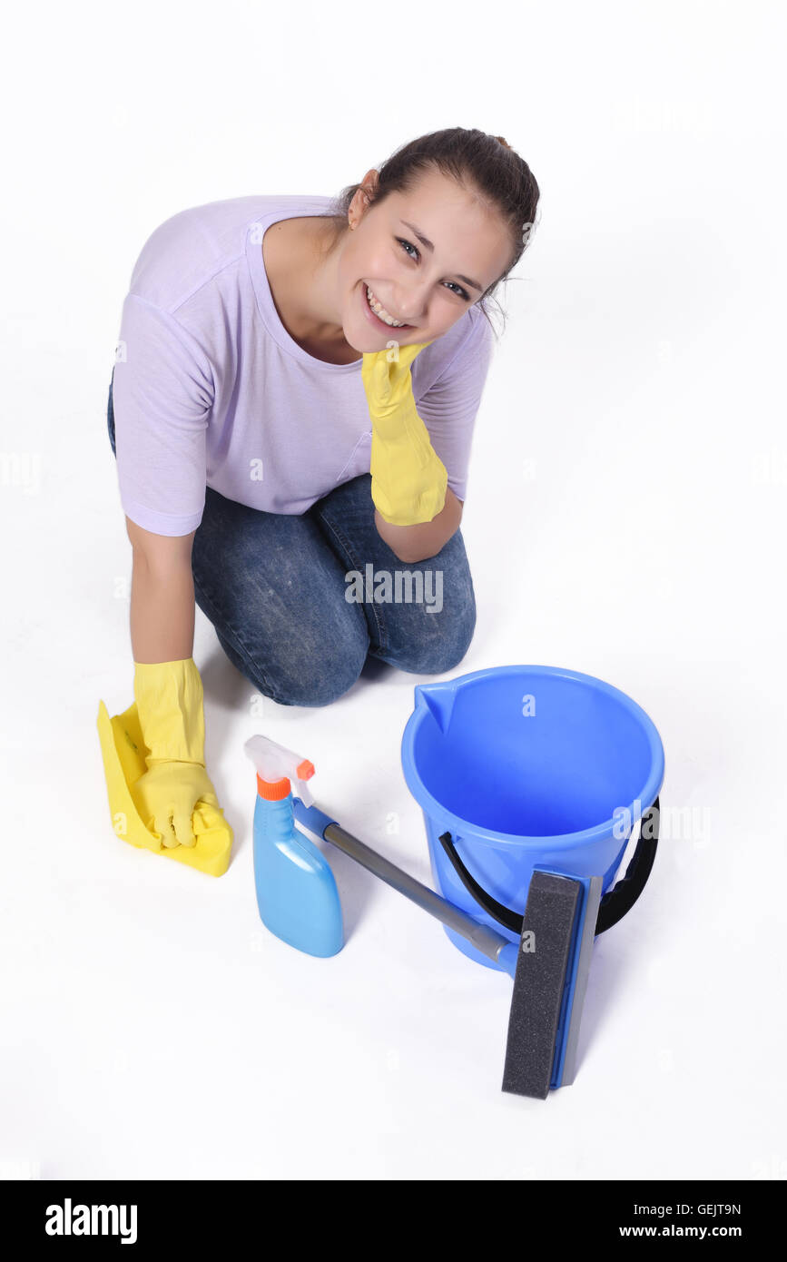 Close up to a young woman doing cleaning against white background. Stock Photo