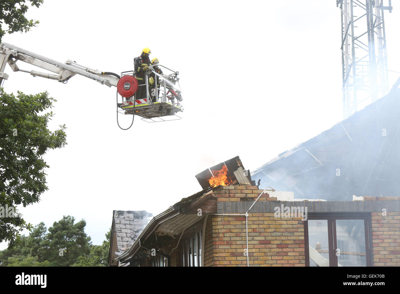 Bordon, Hampshire, UK. 26th July, 2016. More than 50 firefighters are tackling a major blaze at a trading estate in Bordon. It is at Highview, with Hampshire Fire and Rescue sent eight appiances to the. scene. An aerial ladder platform has also been called. In to support the crews. They got the call just before 2pm this afternoon and continue to fight the fire. We are told fire crews have entered the building with breathing apparatus. We understand four units are affected on the roof space and part of the. Roof. And supporting walls have collapsed Credit:  uknip/Alamy Live News Stock Photo