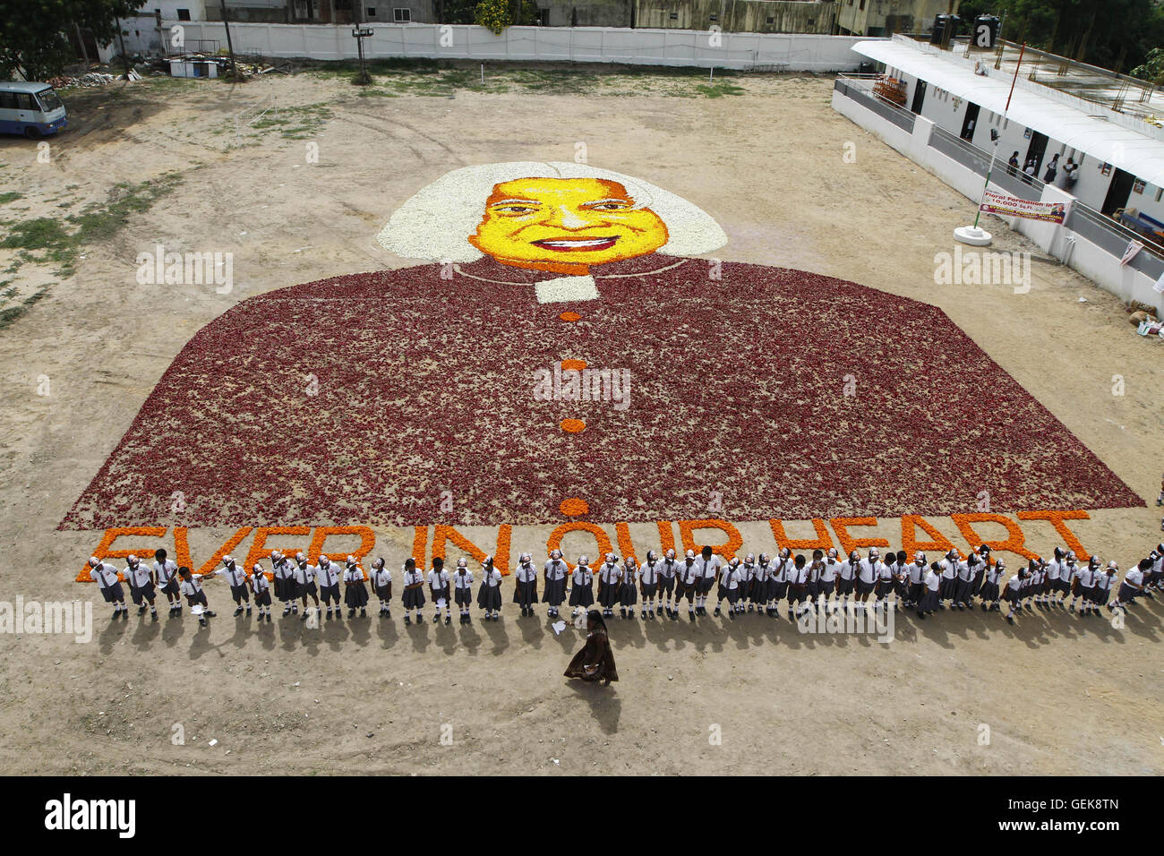 Chennai. 27th July, 2016. Students stand near a floral portrait of former president A.P.J. Abdul Kalam at a school in Chennai, India, July 26, 2016. Kalam died on July 27 last year, at the age of 83. Credit:  Xinhua/Alamy Live News Stock Photo