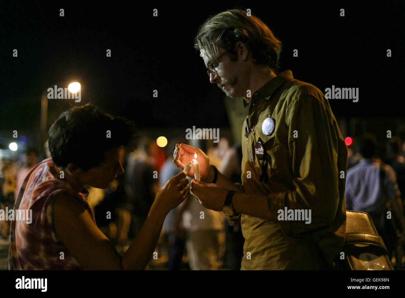 Philadelphia, Pennsylvania, USA. 26th July, 2016. Democratic National Convention. Wes Schnitker from St. Louis helps another Bernie Sanders supporter light a candle outside the DNC on July 26th, 2016. Credit:  John Orvis/Alamy Live News Stock Photo