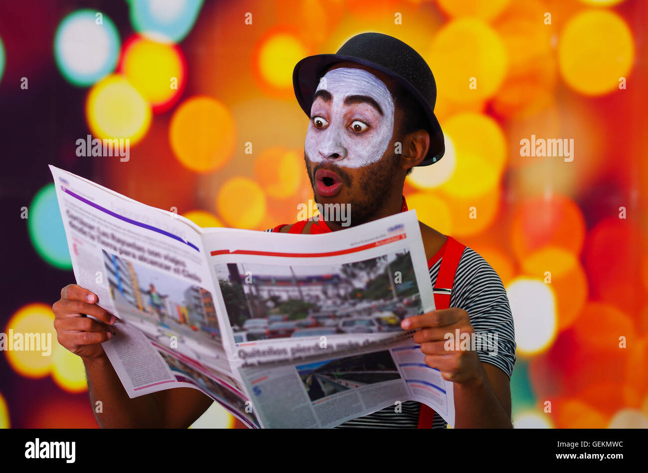 Pantomime Man With Facial Paint Posing For Camera Holding Newspaper Showing Funny Face Blurry Lights Background Stock Photo Alamy