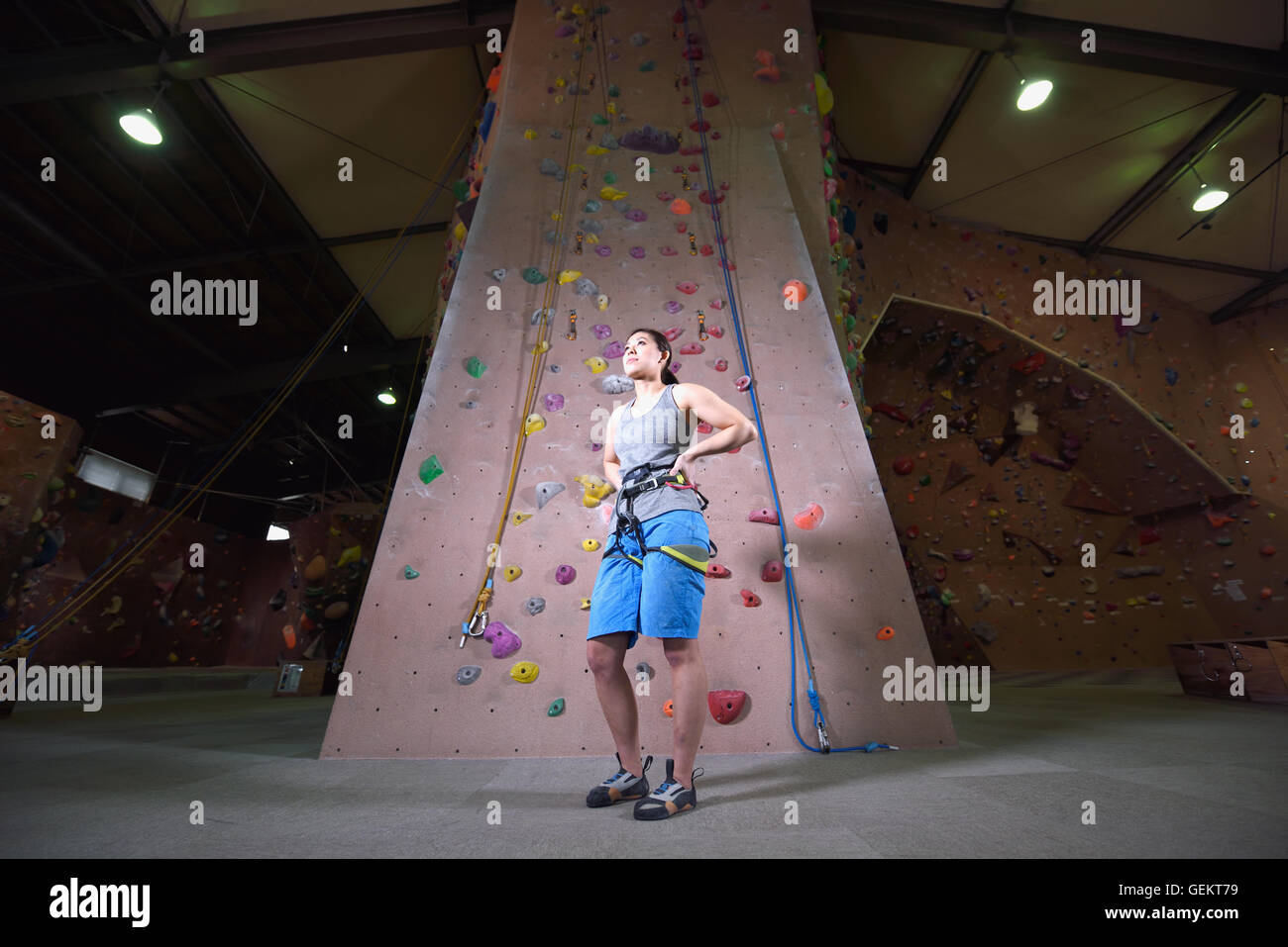 Japanese climbing athlete getting ready to climb gym wall Stock Photo