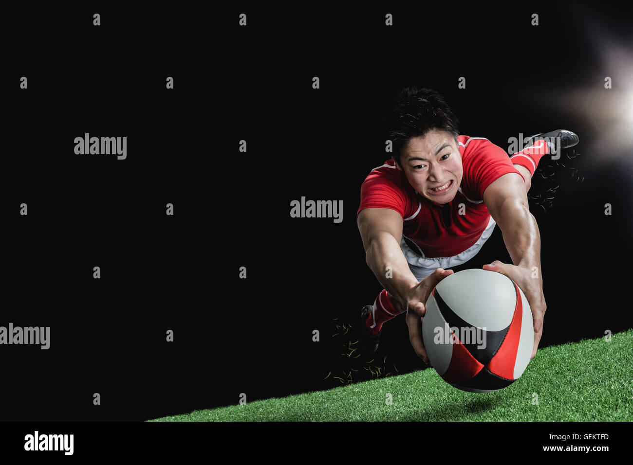 Portrait of Japanese rugby player diving to score a try Stock Photo