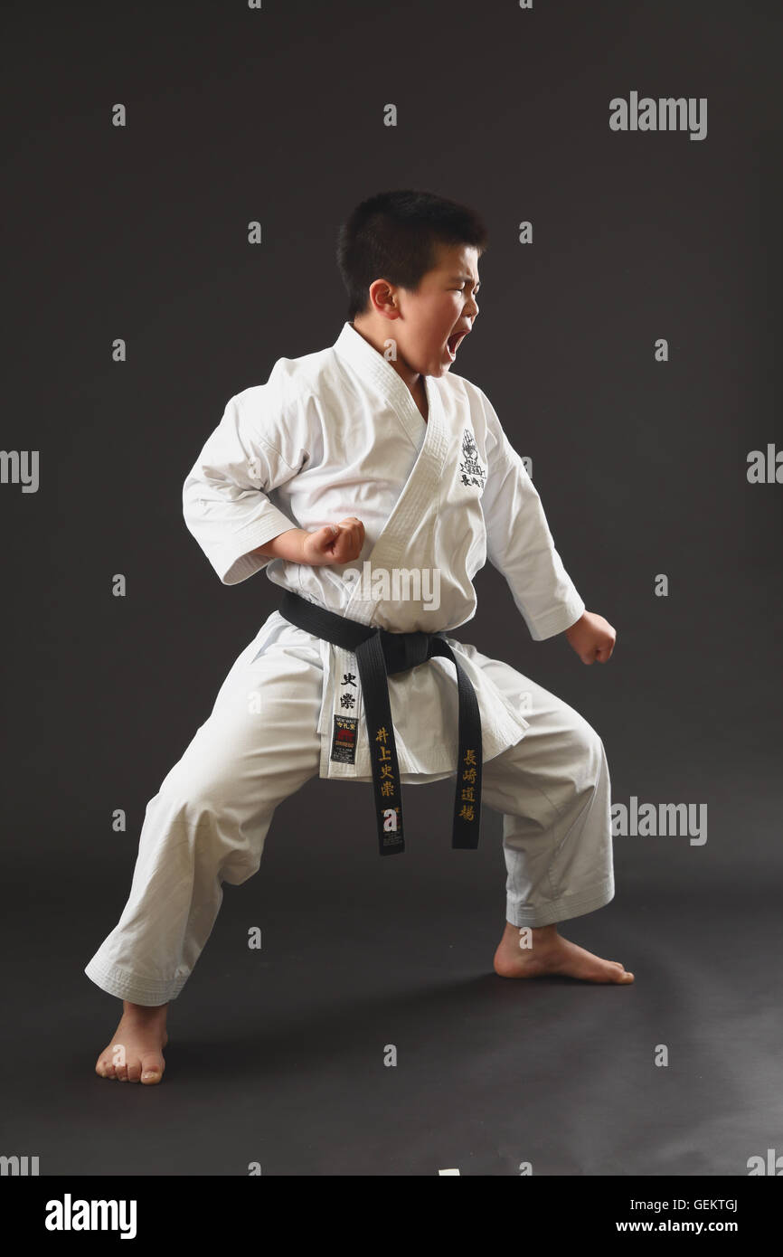 Japanese kid in karate uniform on black background Stock Photo Alamy