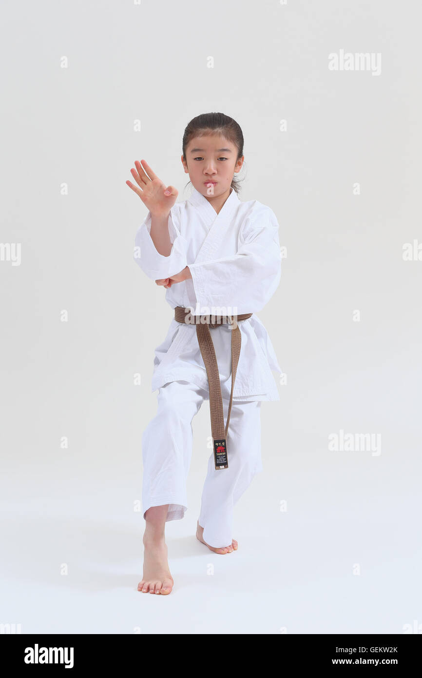 Japanese kid in karate uniform on white background Stock Photo Alamy