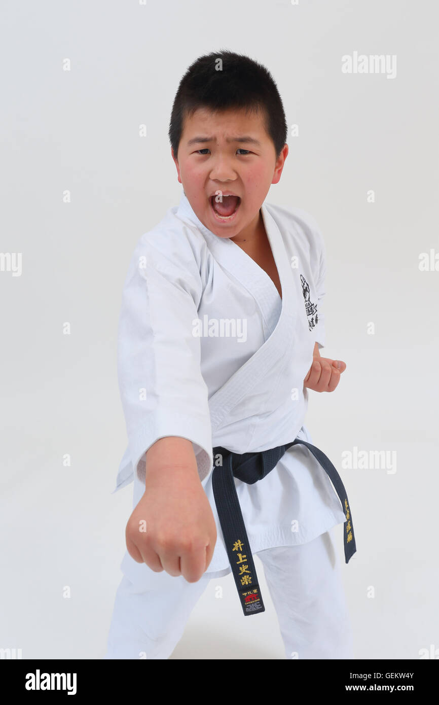 Japanese kid in karate uniform on white background Stock Photo Alamy