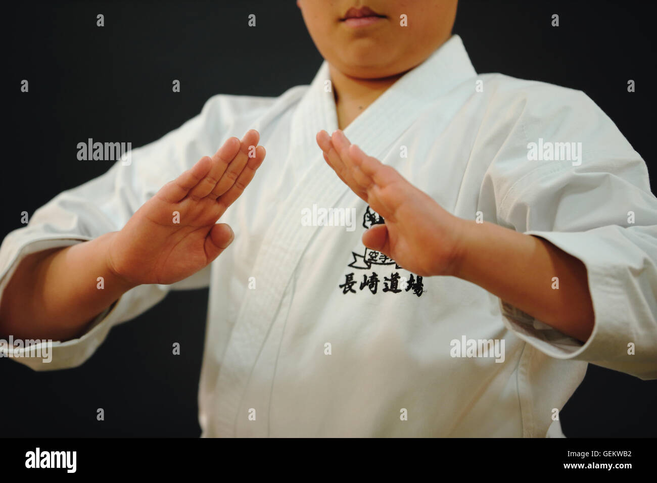 Japanese kid in karate uniform on black background Stock Photo