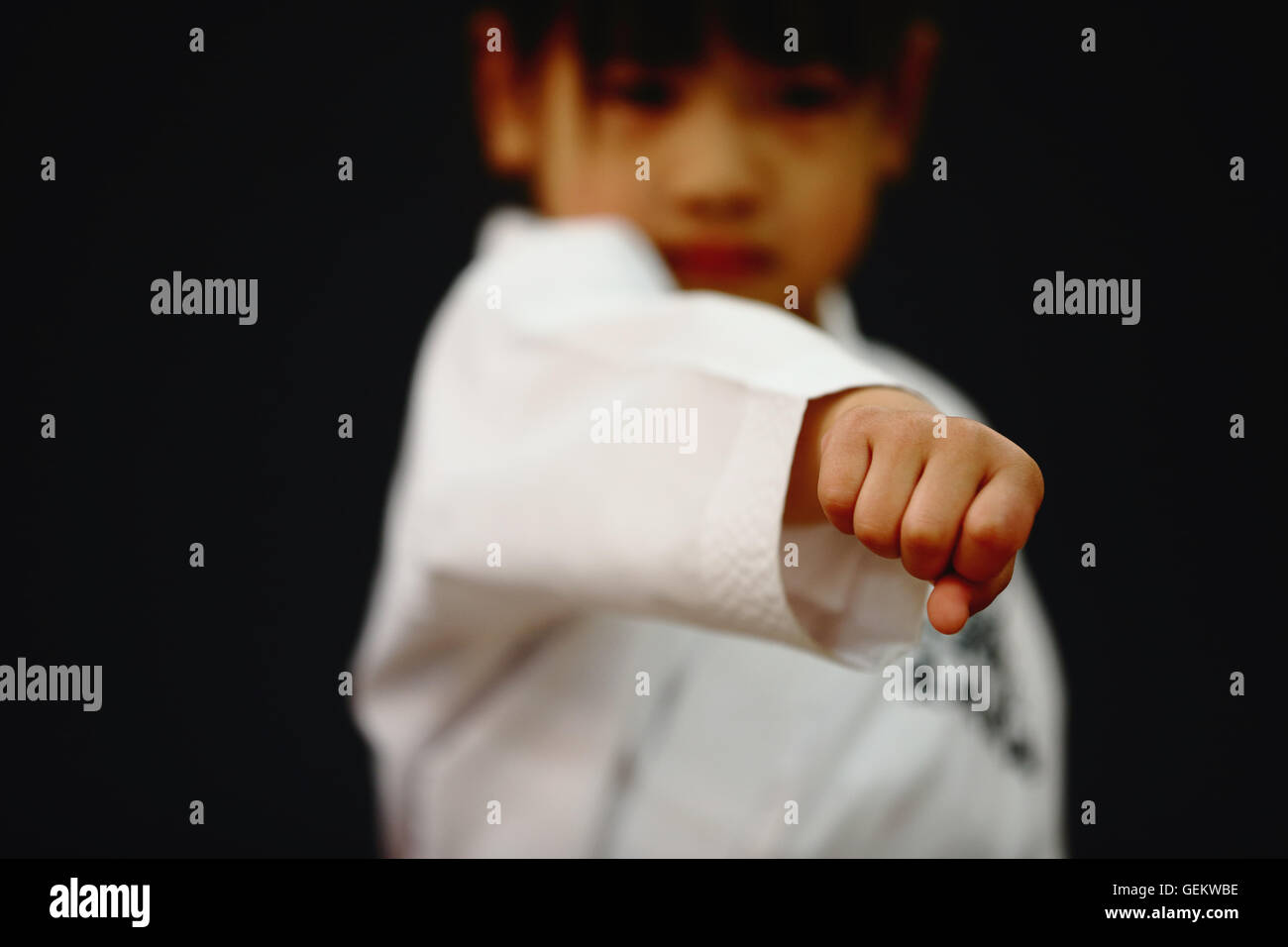 Japanese kid in karate uniform on black background Stock Photo Alamy