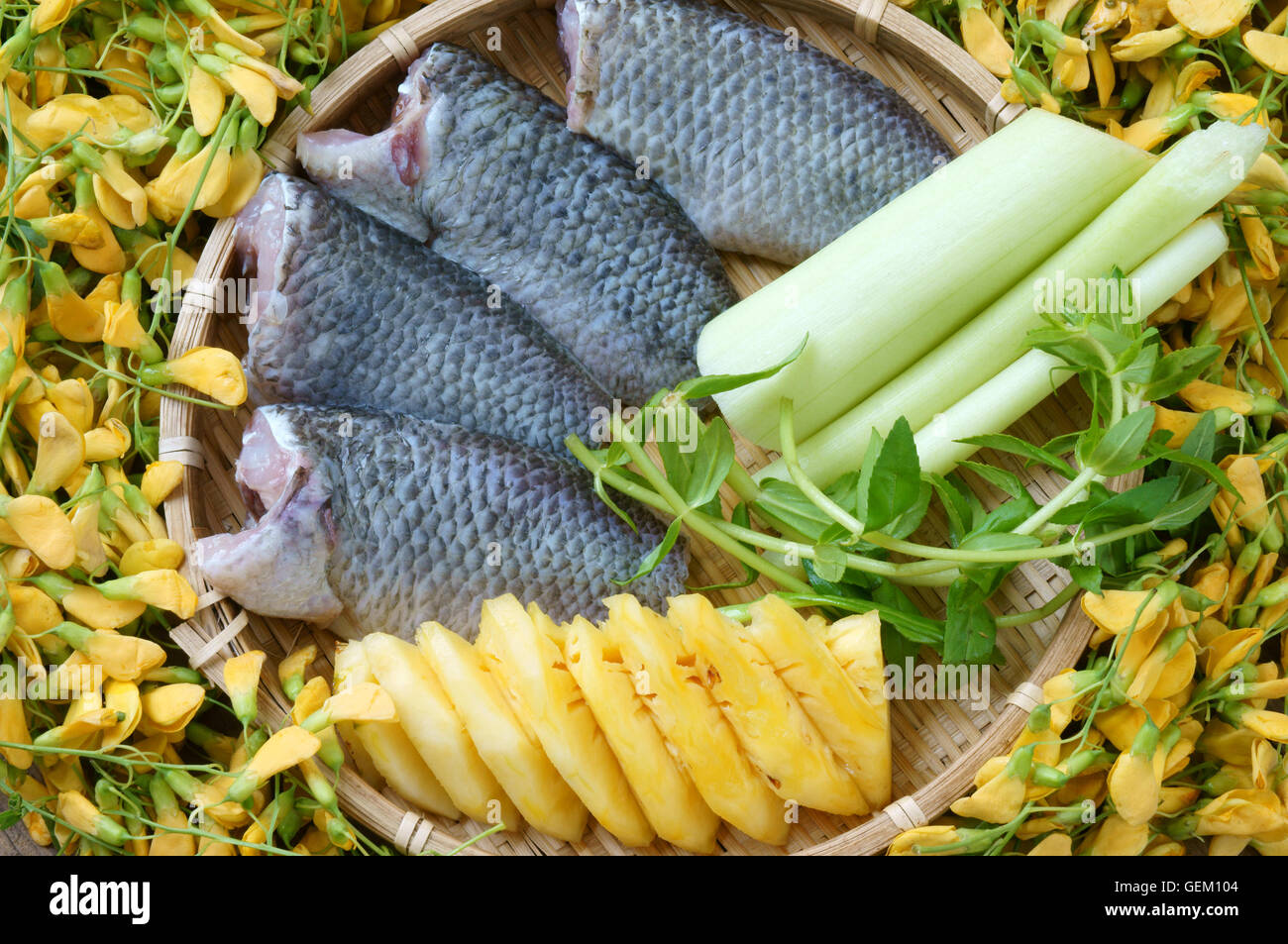 Vietnamese food, sour fish vegetable soup, ingredients fish, pineapple, tamarind, coriander, common sesban or bong dien dien, eating of Mekong Delta Stock Photo