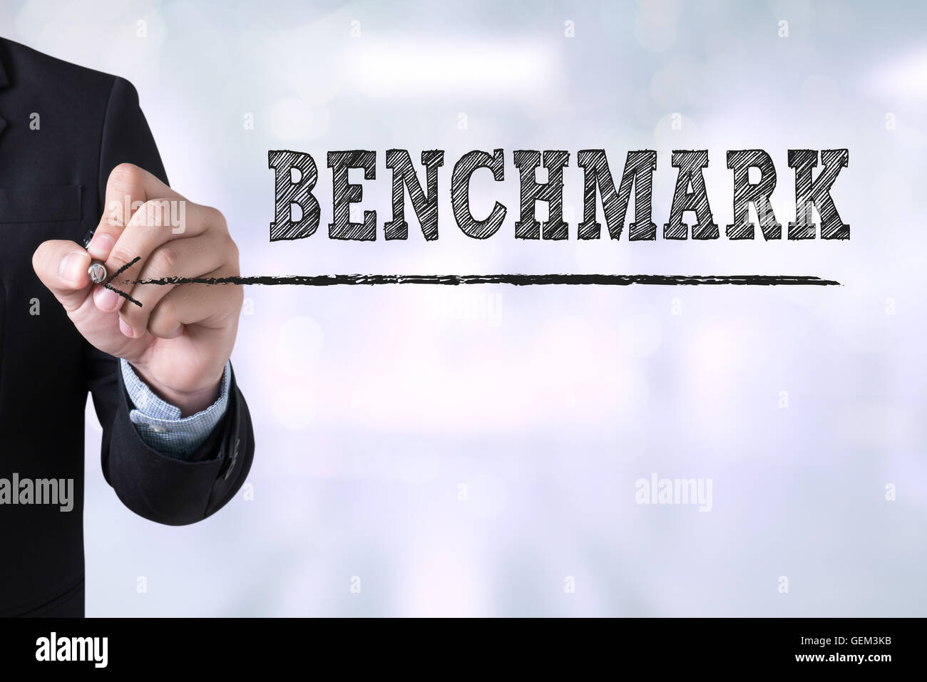 BENCHMARK Businessman drawing Landing Page on blurred abstract background Stock Photo