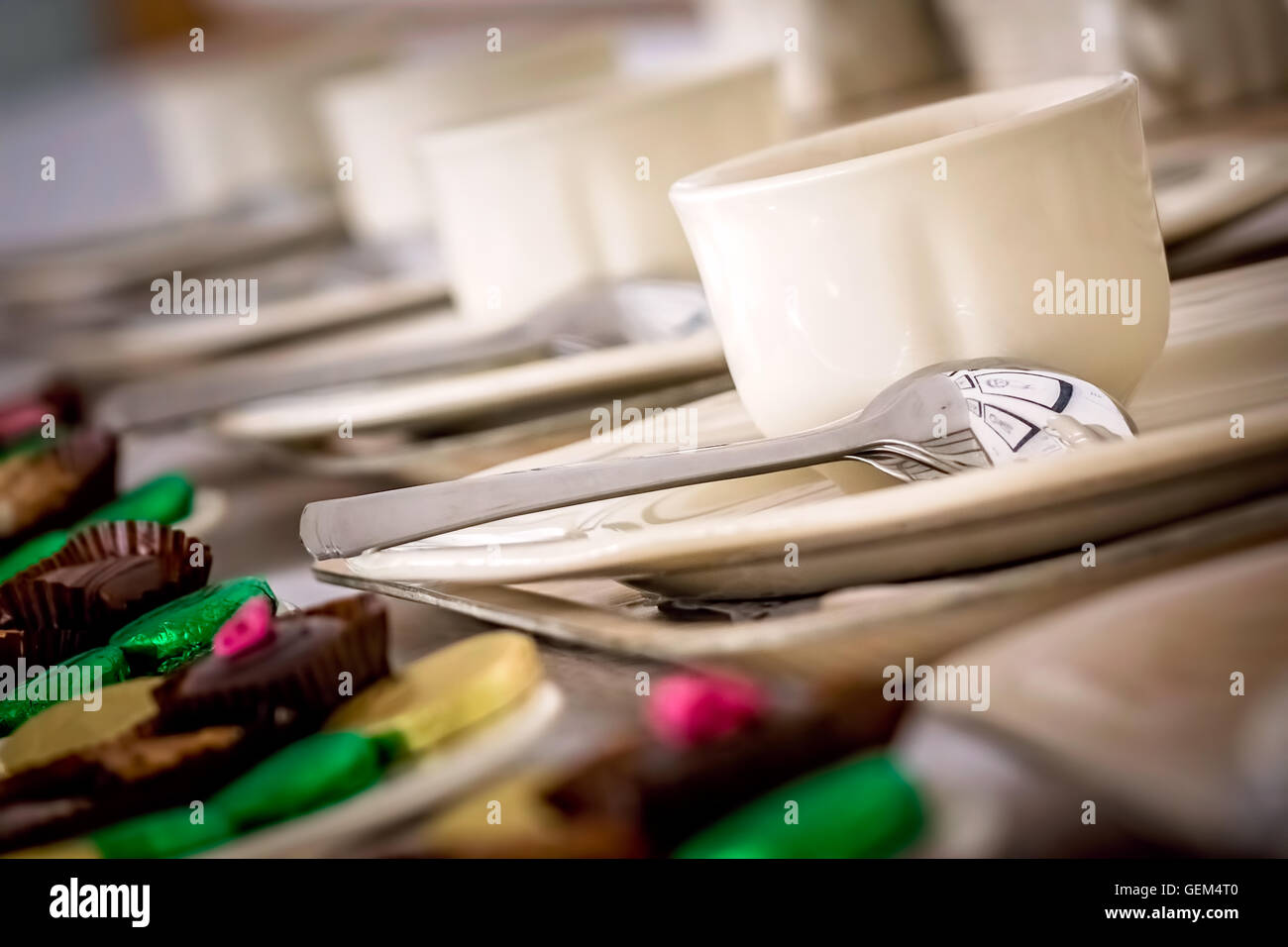 Anniversary event reception table with mints and sweets and coffee cups Stock Photo