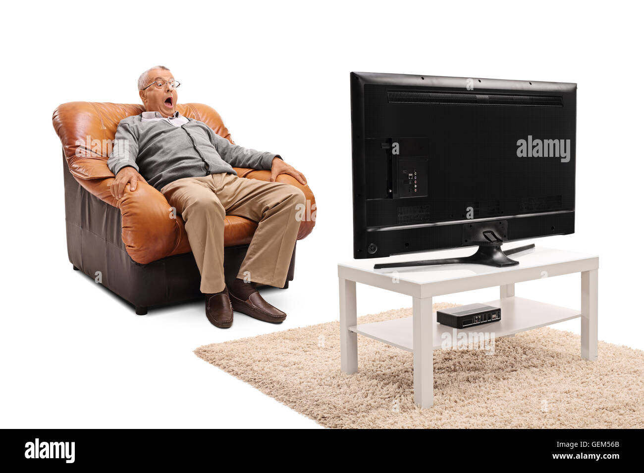 Terrified senior watching a scary movie on TV seated on an armchair