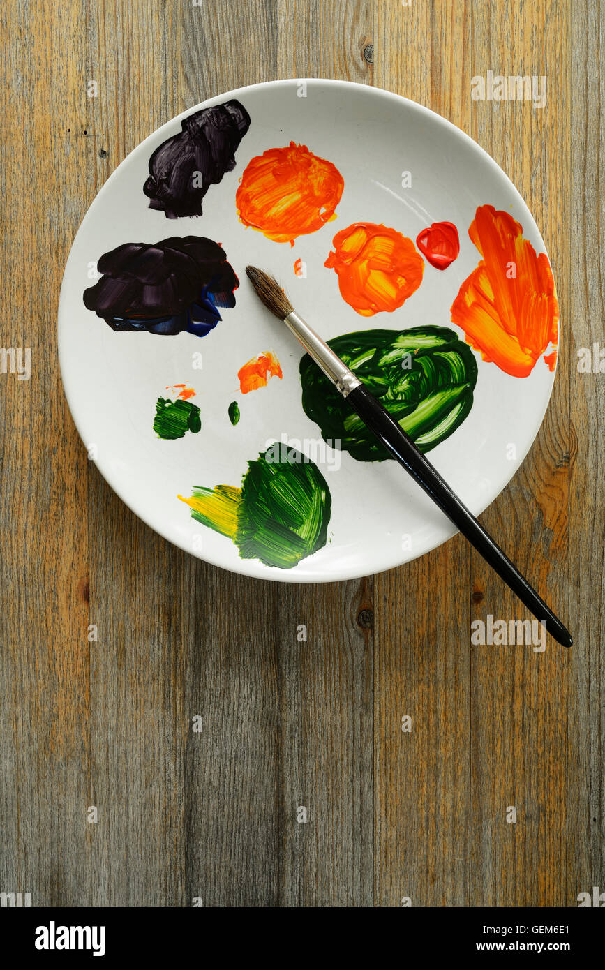 brush and paints on a white plate Stock Photo Alamy