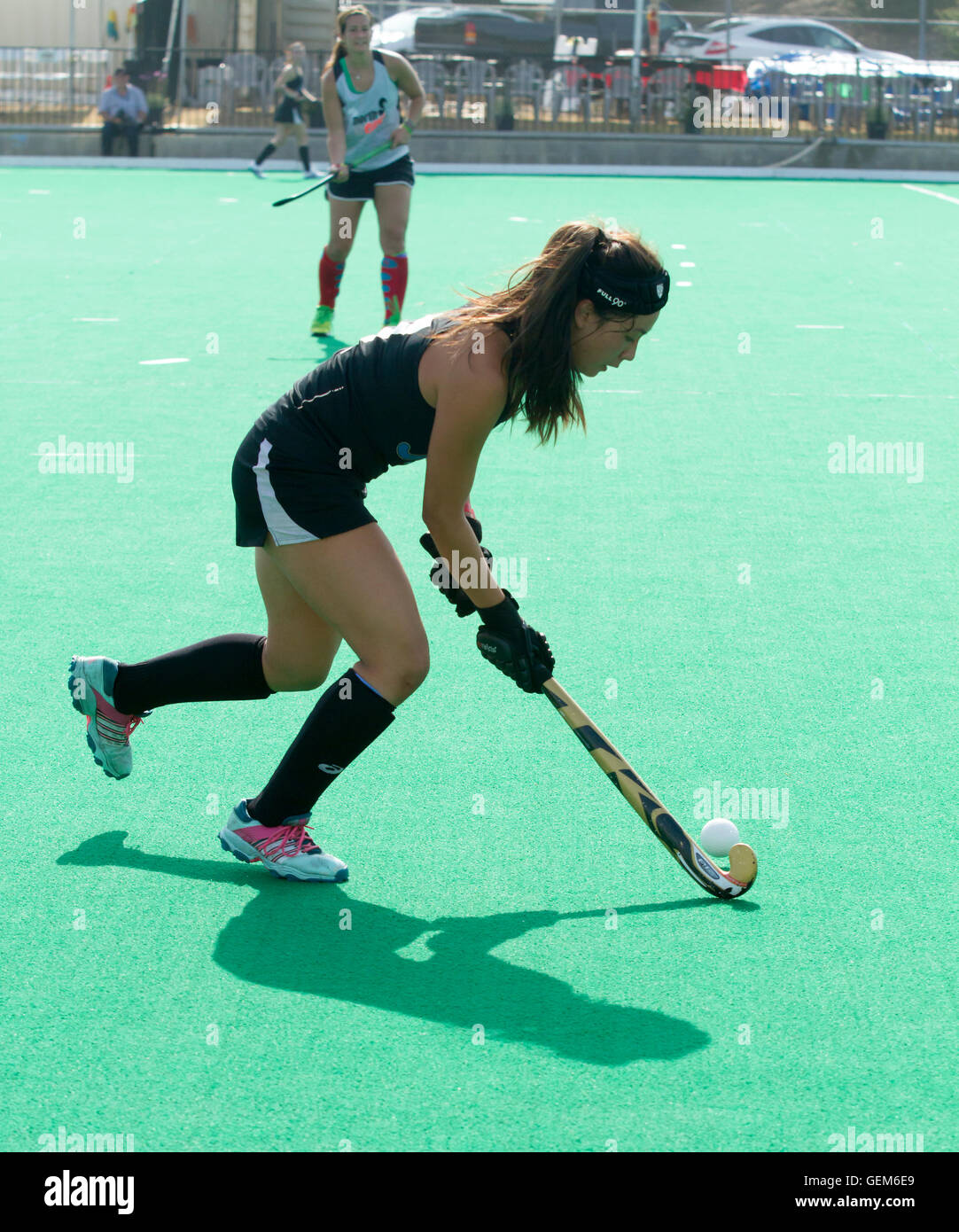 Female field hockey player  preparing to take make a pass Stock Photo