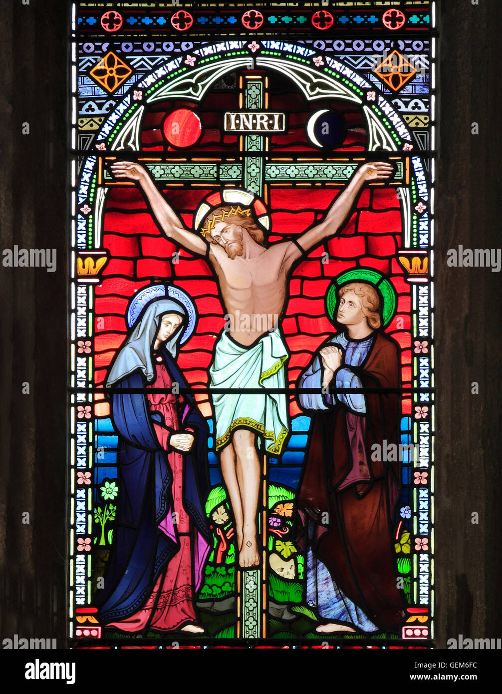 The Crucifixion of Jesus, with Mary and John, Old Hunstanton, detail of stained glass window by Frederick Preedy, 1867 Stock Photo