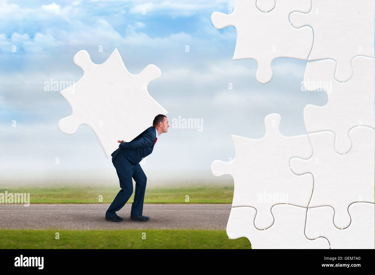 business puzzle concept businessman faces adversity to solve jigsaw Stock Photo