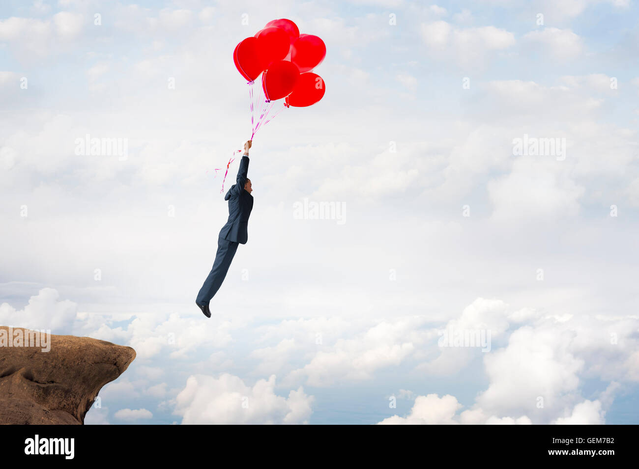 business success concept businessman flying upward with helium balloons Stock Photo