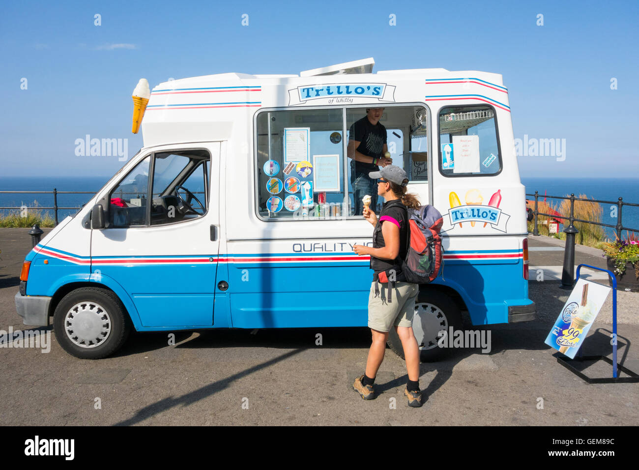 Female walker with backpack buying ice cream From Trillo`s van on top  promenade at Saltburn by the sea, Yorkshire, England. UK Stock Photo - Alamy