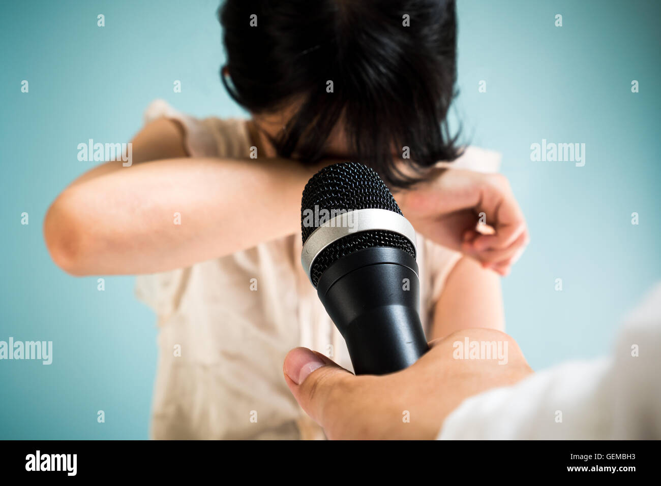 Woman crying at a press conference Stock Photo