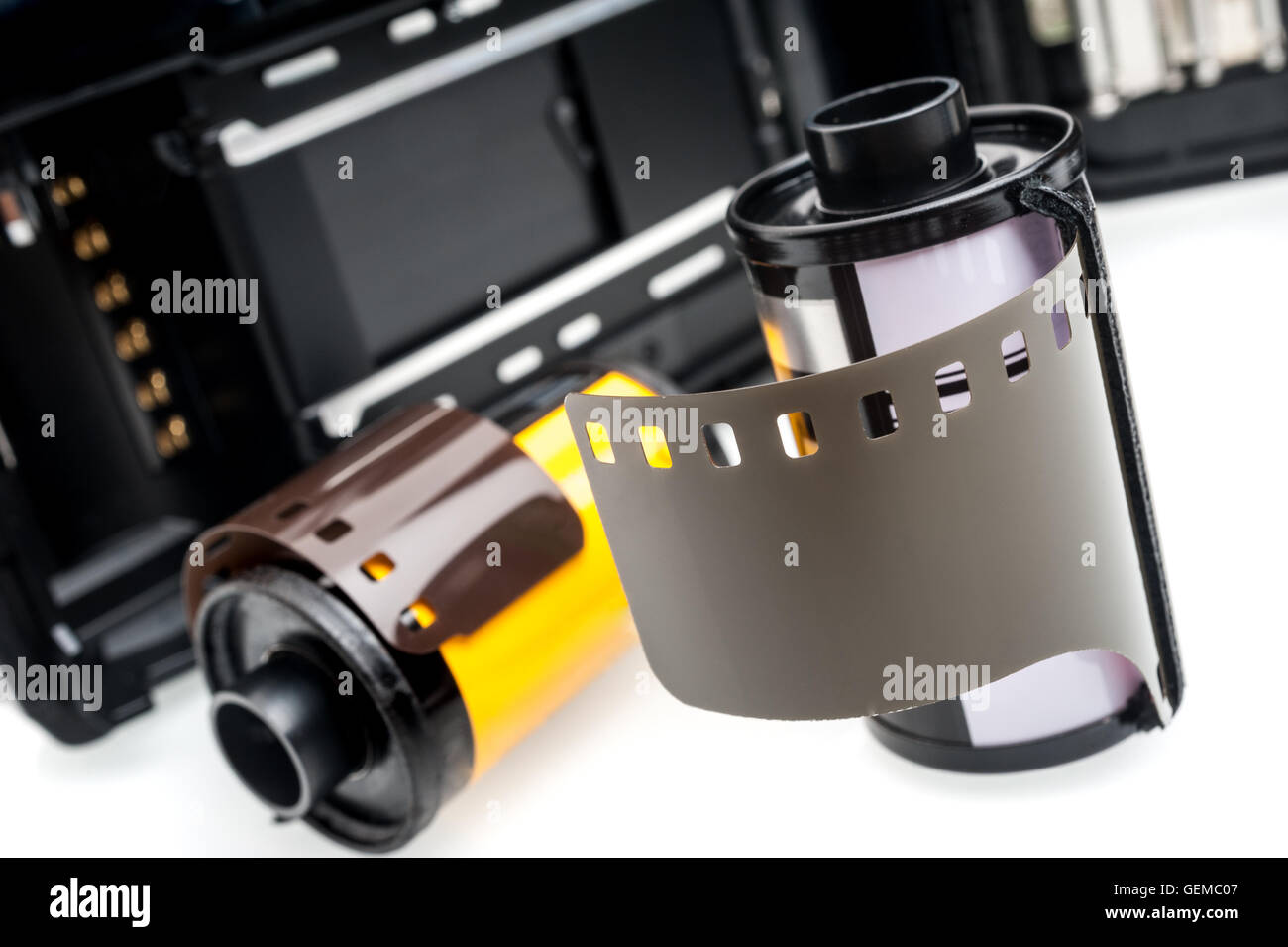 closeup camera film and black camera with opened back lid on white