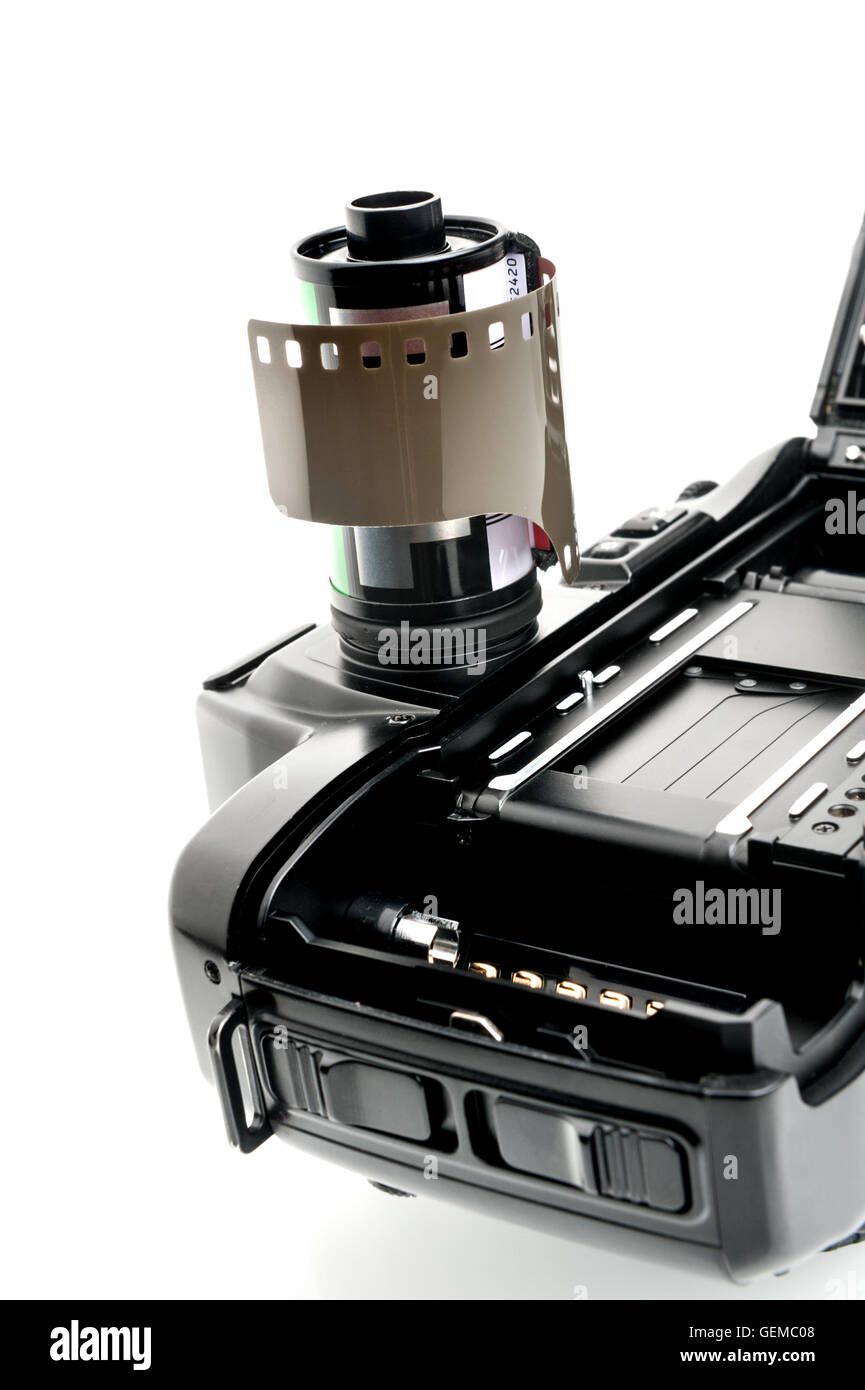 closeup camera film and black camera with opened back lid on white