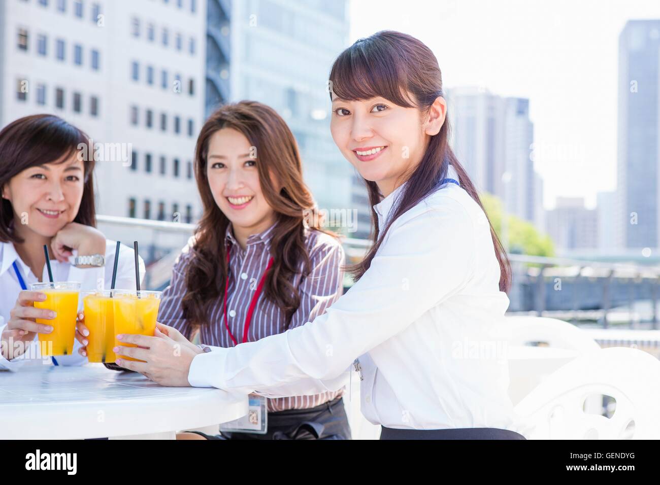 Women making a toast with juice Stock Photo