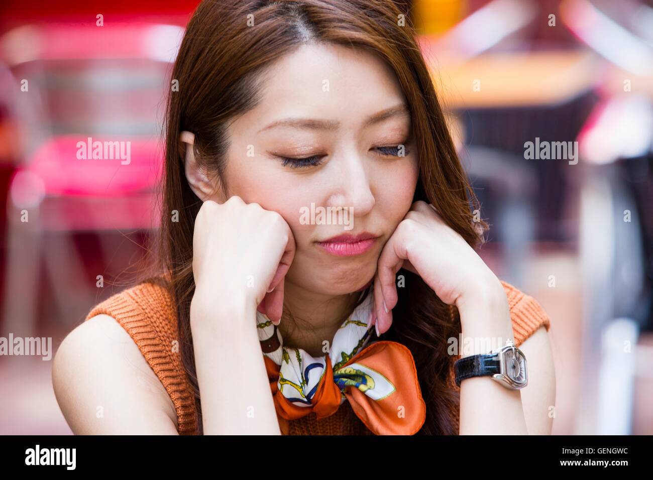 Woman resting her chin on her hands Stock Photo Alamy