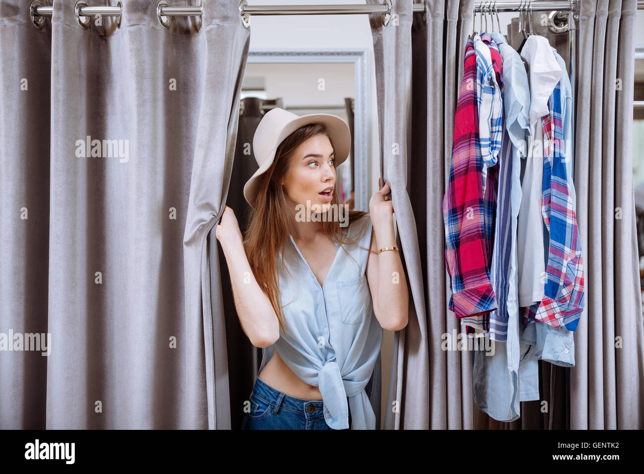 Young Woman Trying On Clothing In Dressing Room Side View High-Res Stock  Photo - Getty Images