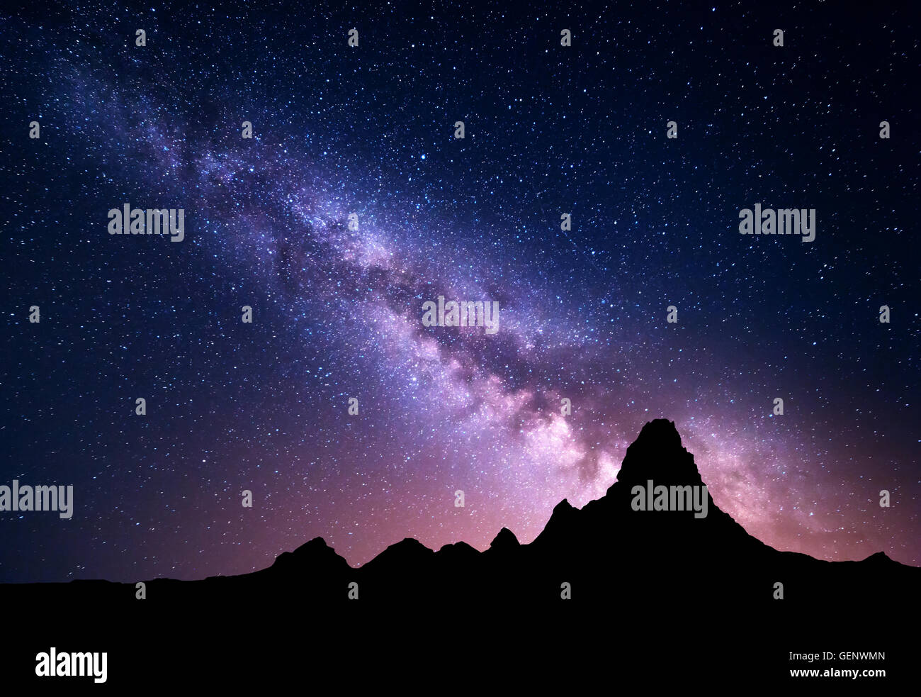 Night landscape with colorful Milky Way and mountain peak. Starry sky with high rocks at summer. Beautiful Universe. Space backg Stock Photo