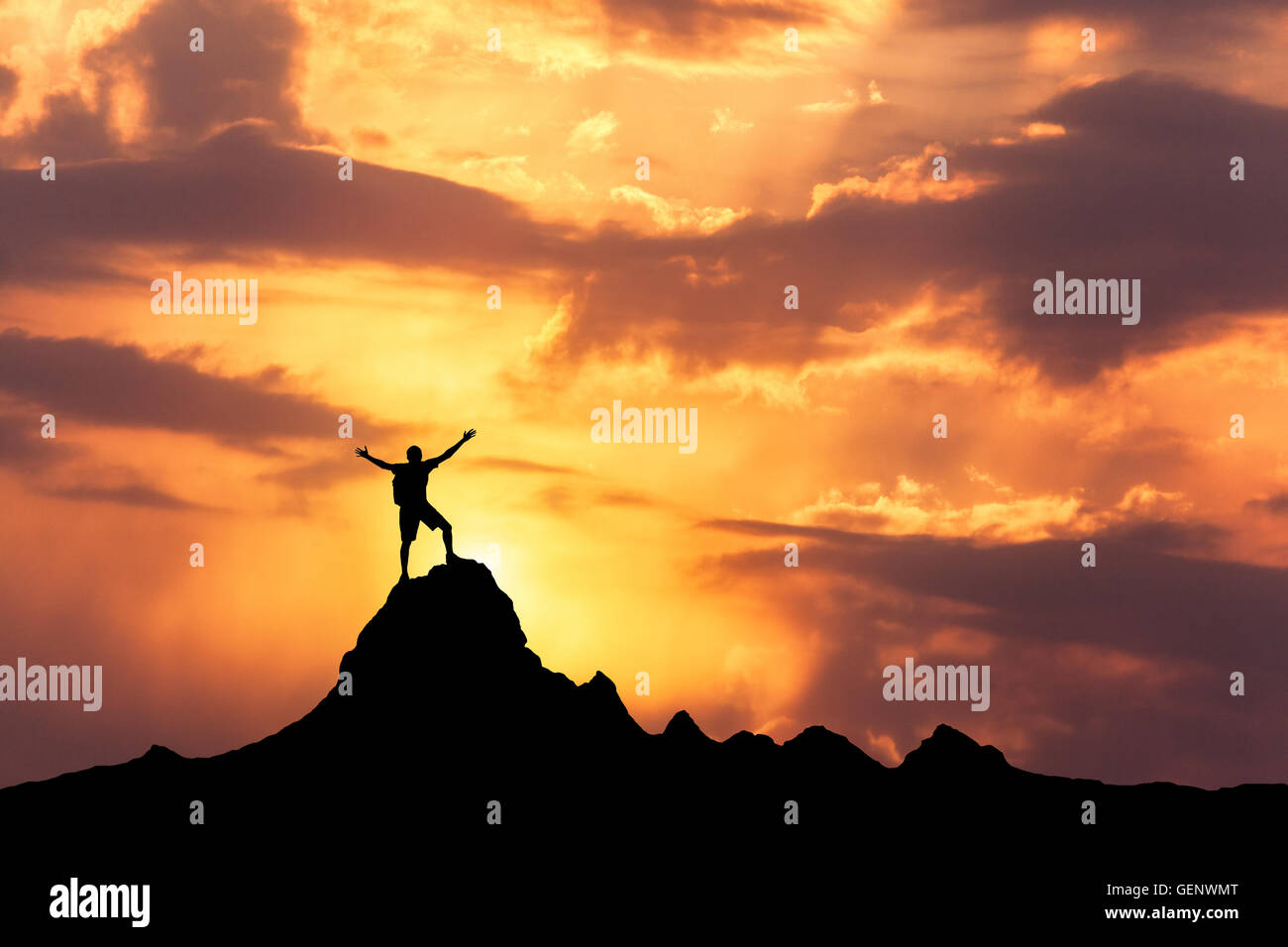 Man standing on top of mountain with arms raised hi-res stock ...