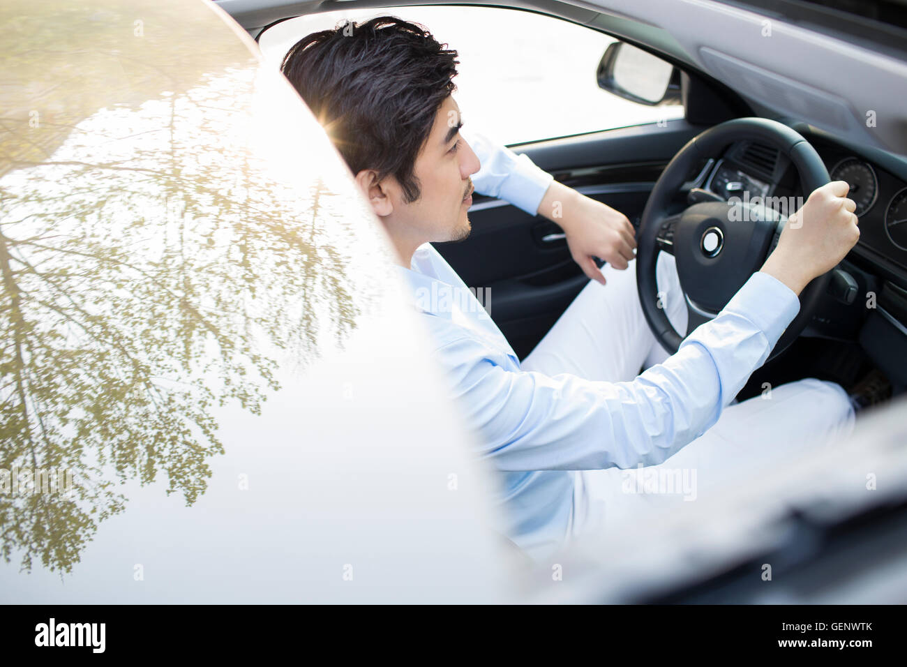 Young Chinese man driving car Stock Photo