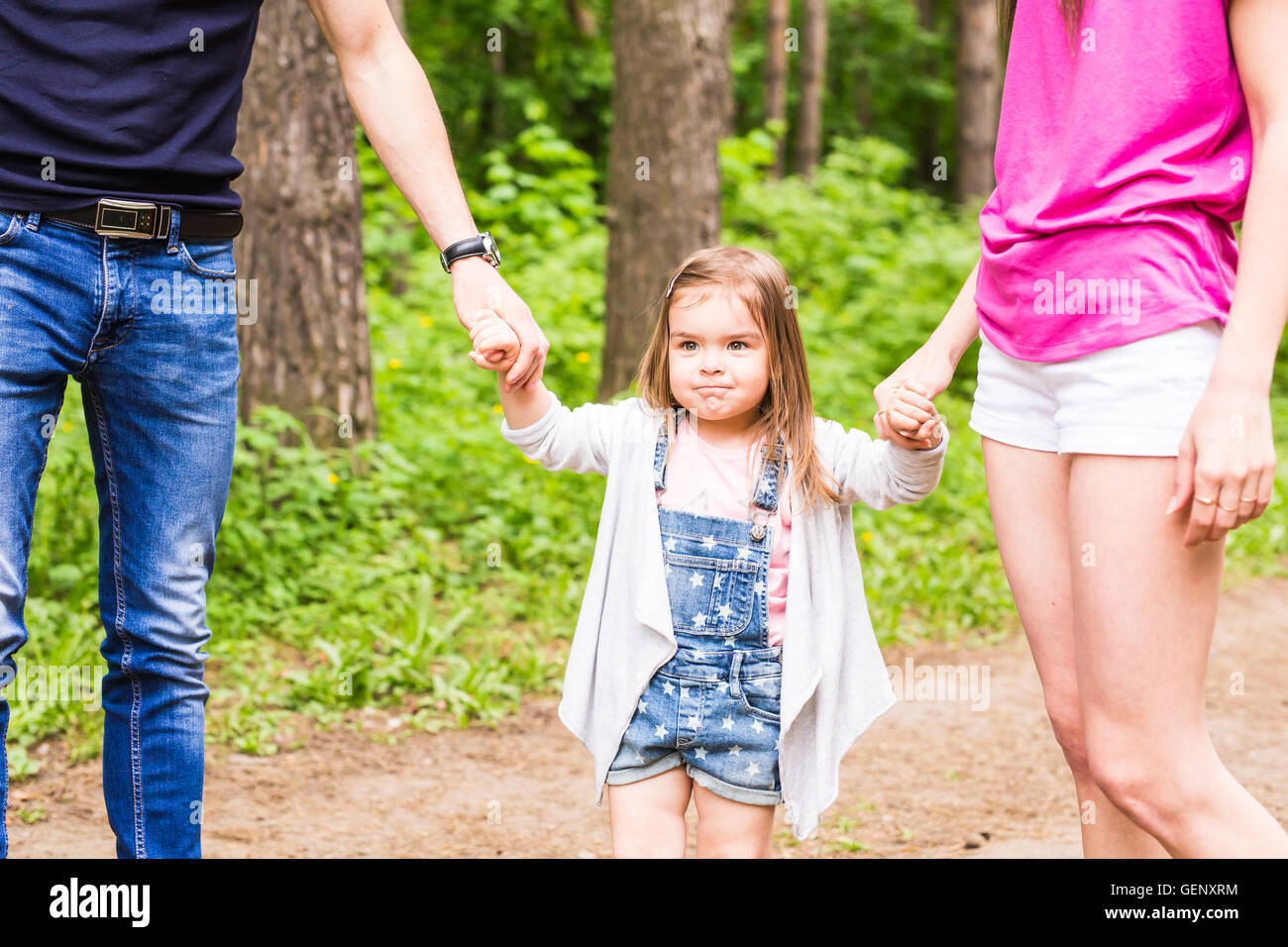 Daughter, parents were holding hands in the park Stock Photo - Alamy