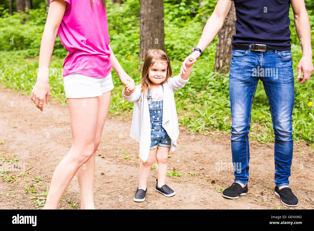 Daughter, parents were holding hands in the park Stock Photo - Alamy