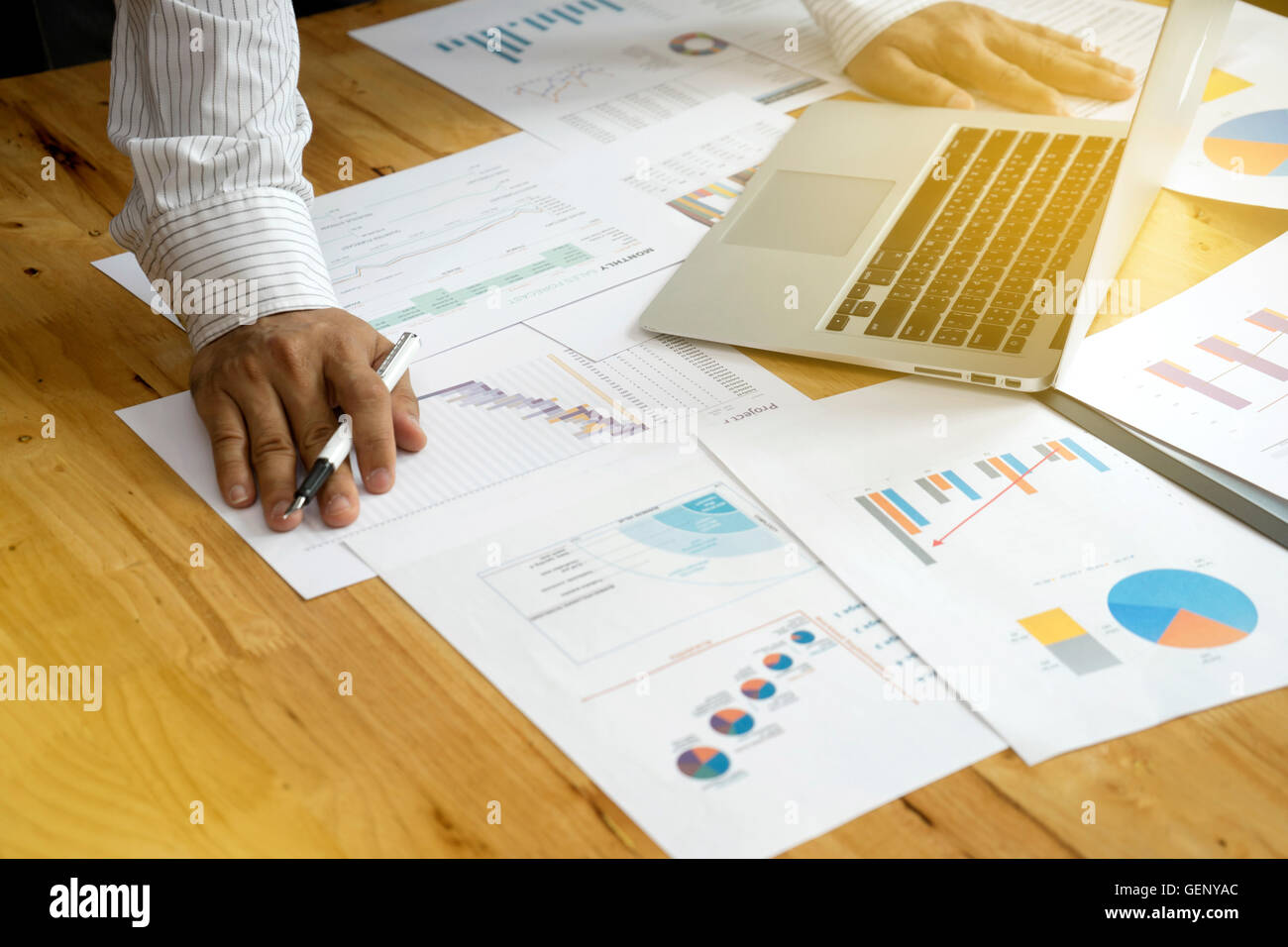 a businessman working plan the business and analysis many chart graph vintage tone sunlight Stock Photo