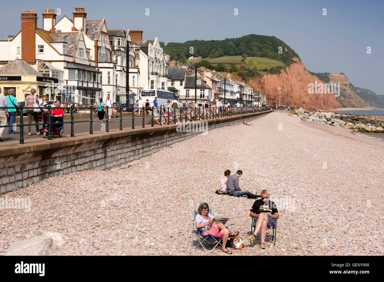 UK, England, Devon, Sidmouth, The Esplanade, older visitors on beach in sunshine Stock Photo