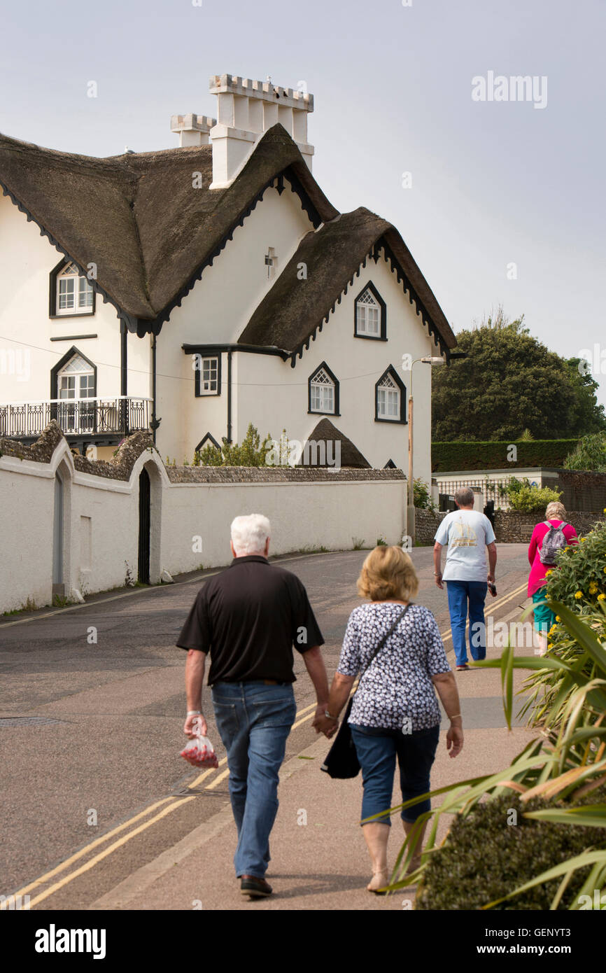 UK, England, Devon, Sidmouth, Peak Hill Road, people walking past Clifton Cottage thatched seafront house Stock Photo