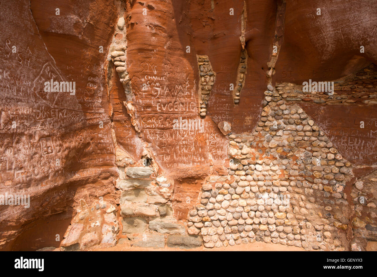 UK, England, Devon, Sidmouth, Clifton Walk, names carved in salt encrusted sandstone cliff, beside waterside path Stock Photo